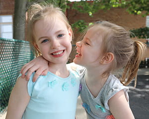 A photo of two girls smiling.